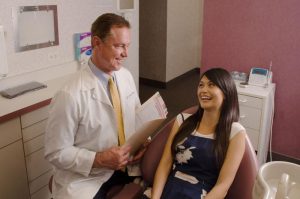 dentist with patient in chair